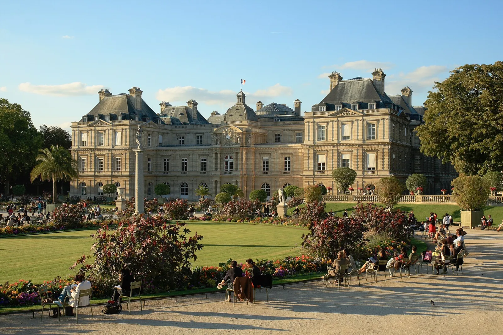 El Palacio del Luxemburgo al atardecer con los parterres floridos del jardín en primer plano